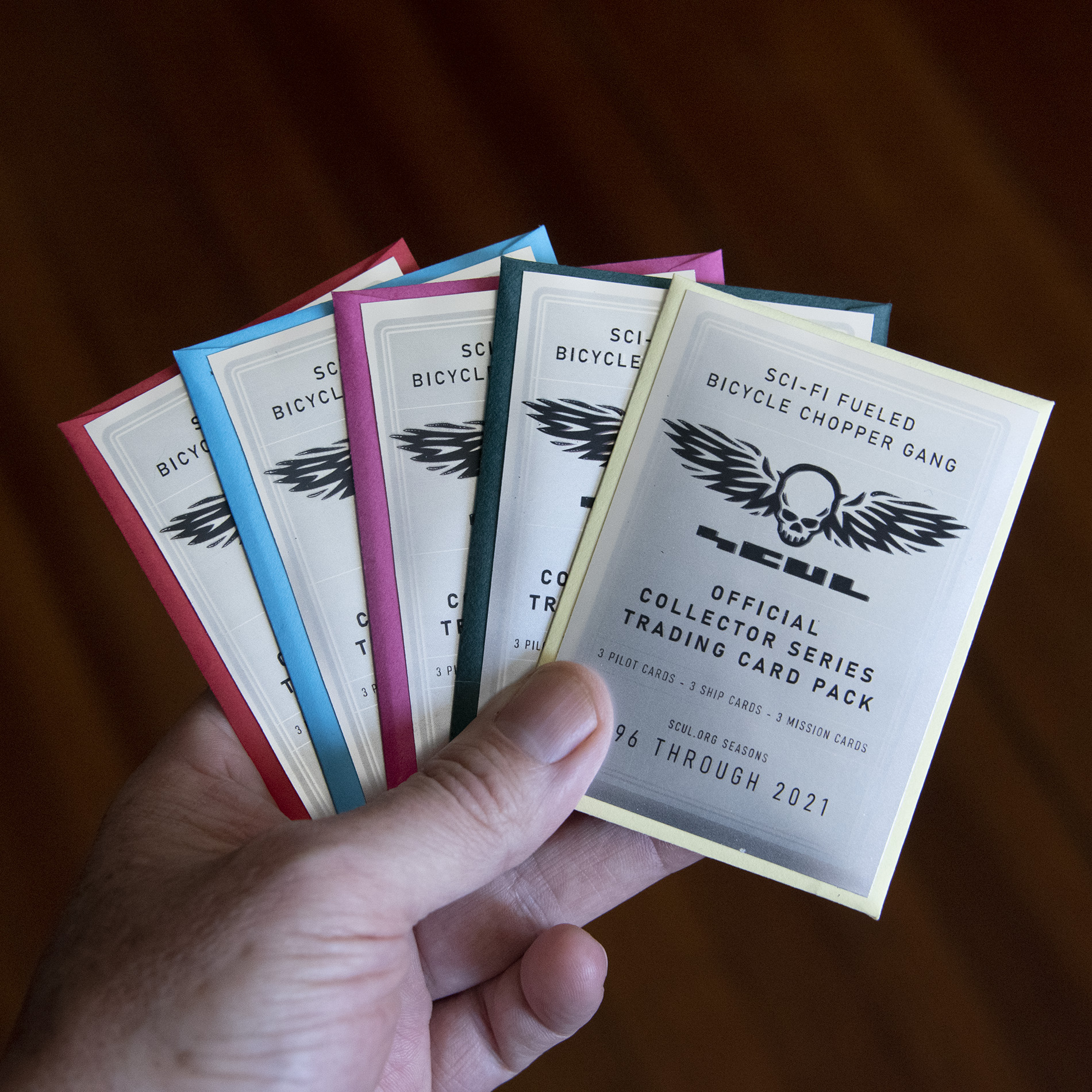 Five Colorful Trading Card Packs with silver foil covers