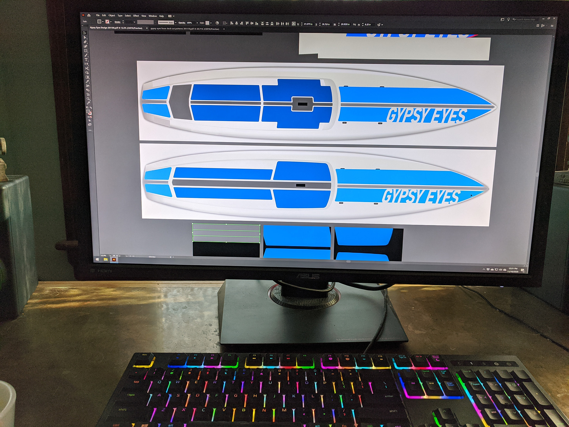 a computer showing graphics designs for an SUP with stipes of varying blues. the words 'gypsy eyes' is cut out the large right-side stripe